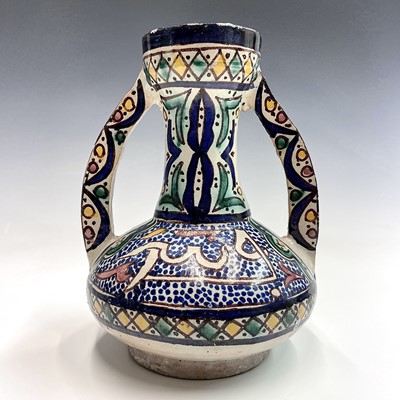 Lot 1007 - A Moroccan pottery twin-handled vase, mid 20th...