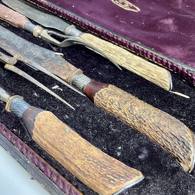 Lot 45 - A Victorian cased meat carving set with antler...
