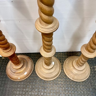 Lot 50 - A matched trio of large wood turned and carved...