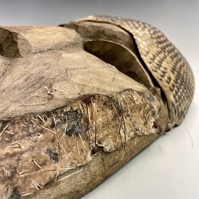 Lot 74 - An African mask with snakeskin detail, length...