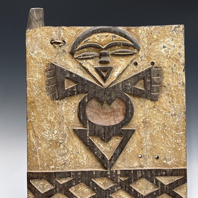 Lot 77 - An African wood carved panel of a stylised...
