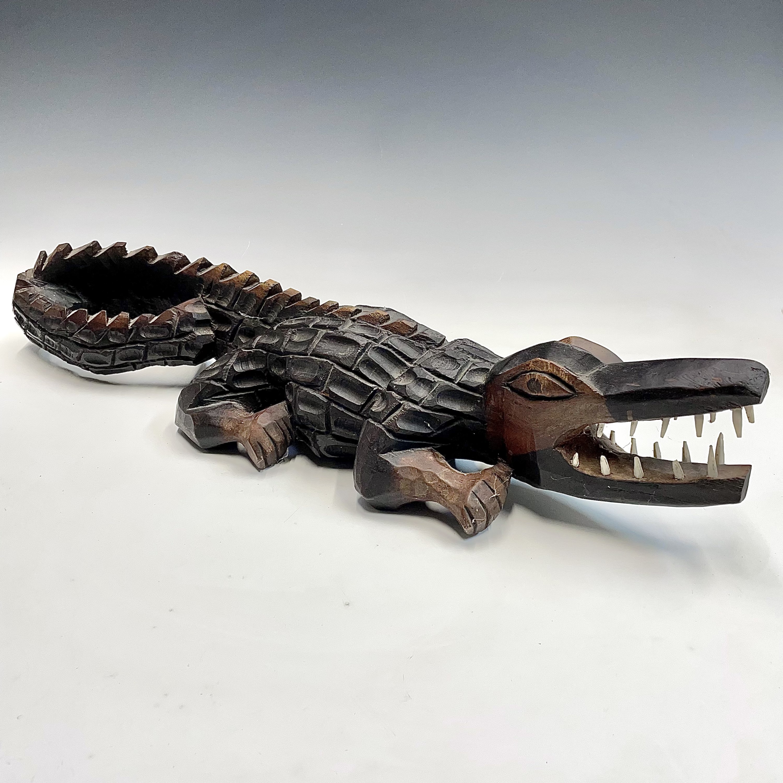 Lot 199 - An African wood carved crocodile with bone