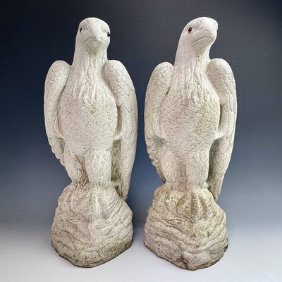 Lot 605 - A pair of reconstituted stone birds of prey,...