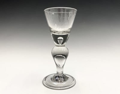 Lot 1003 - An early 18th century heavy baluster wine...