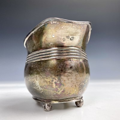 Lot 63 - A George III silver milk jug with ribbed...