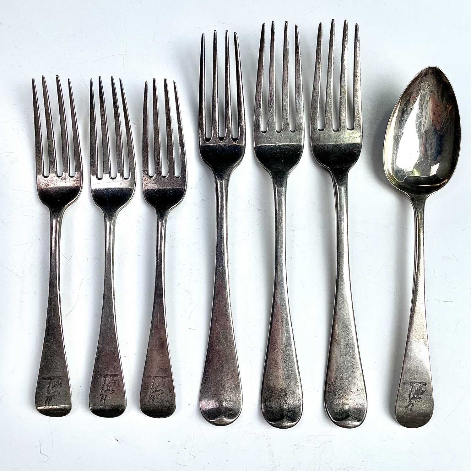 Lot 66 - Three George III silver table forks, London...