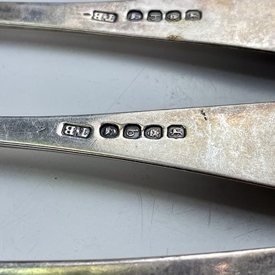 Lot 66 - Three George III silver table forks, London...