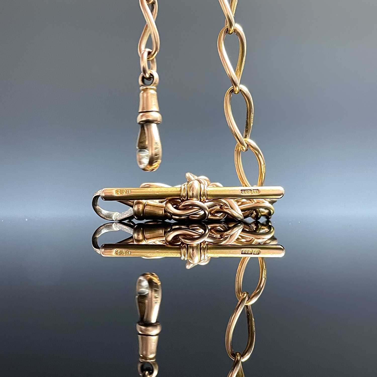 Lot 793 - A 15ct gold curb link double watch chain...