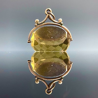 Lot 744 - A yellow metal mounted citrine swival fob,...