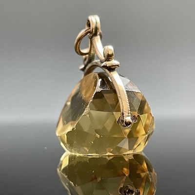 Lot 744 - A yellow metal mounted citrine swival fob,...