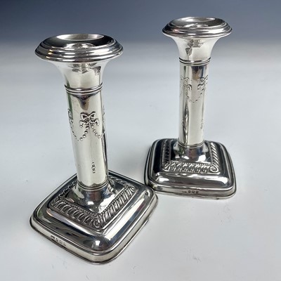 Lot 73 - A pair of George V silver candlesticks by...