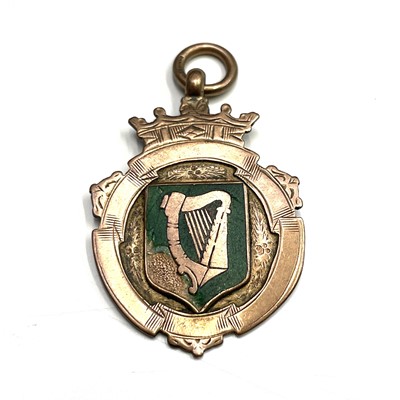Lot 674 - A 9ct hallmarked rose gold and green enamel...