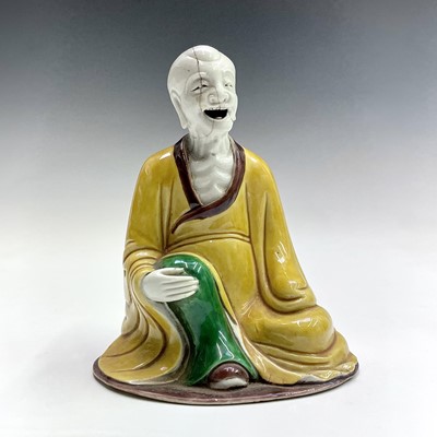 Lot 59 - A Chinese sancai-glazed figure of a seated...