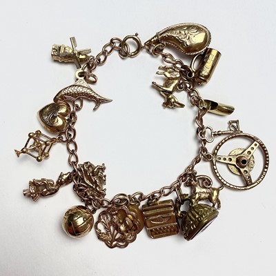 Lot 720 - A 9ct Gold charm bracelet, comprising 17 gold...