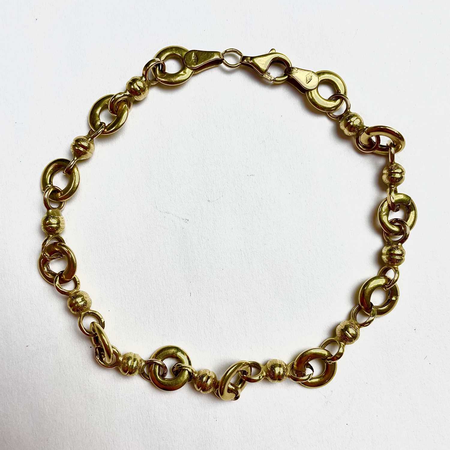 Lot 678 - An 18ct gold fancy link bracelet, stamped