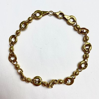 Lot 678 - An 18ct gold fancy link bracelet, stamped 750,...