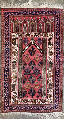 Lot 1218 - An Afghan prayer rug, circa 1930, the madder...