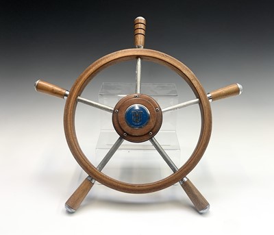 Lot 165 - A teak ships wheel with a Viking boat badge,...