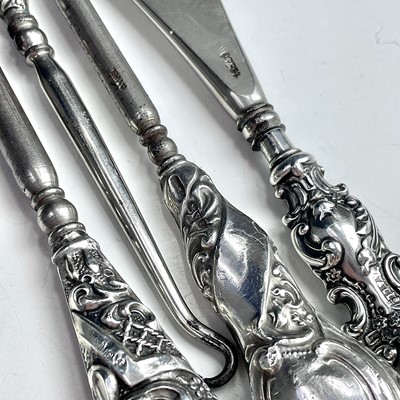 Lot 93 - Four dressing table implements with silver...