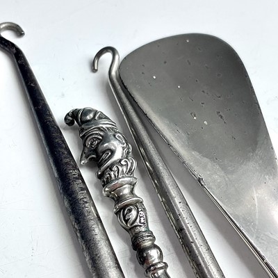 Lot 93 - Four dressing table implements with silver...