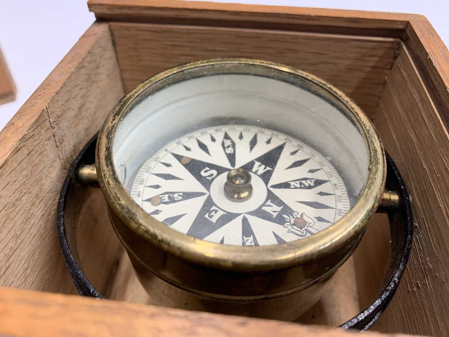 Lot 279 - An unmarked brass compass in a cast metal