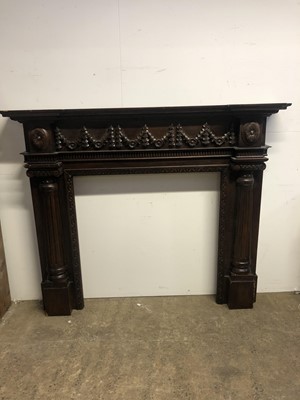 Lot 3100 - An oak fire surround decorated with garland...