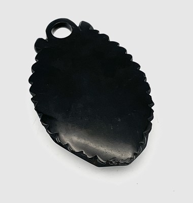 Lot 665 - A Victorian Whitby carved Jet oval pendant set...