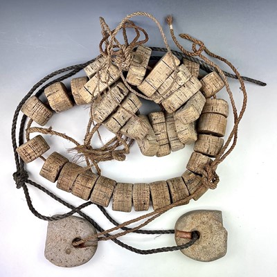 Lot 153 - Two strings of cork floats and stoneware end...