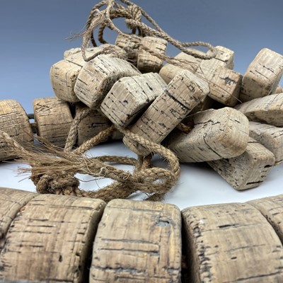 Lot 153 - Two strings of cork floats and stoneware end...