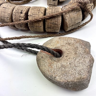 Lot 153 - Two strings of cork floats and stoneware end...