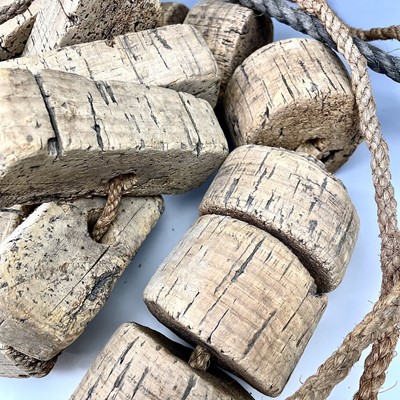 Lot 153 - Two strings of cork floats and stoneware end...