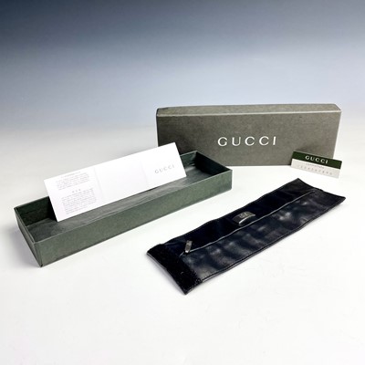 Lot 1017 - A Gucci unisex black leather wrist wallet,...