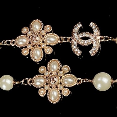 Lot 1053 - A Chanel rose gold plated, white enamel and...