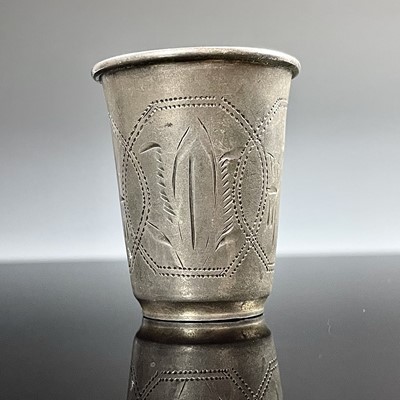 Lot 100 - A Russian silver vodka cup, engraved with...