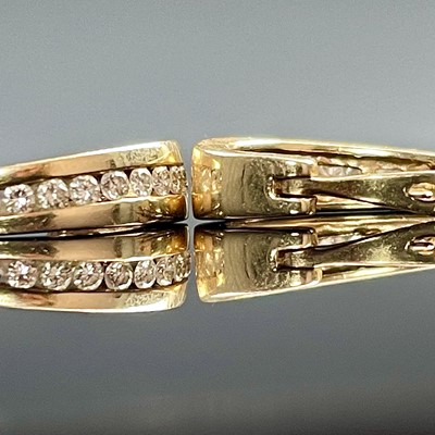 Lot 767 - A pair of 10k gold diamond channel set...