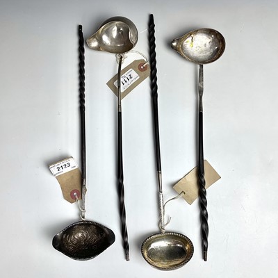Lot 138 - Four Georgian silver toddy ladles with twisted...