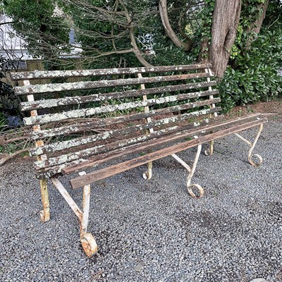 Lot 608 - A wrought iron and slatted bench originally...