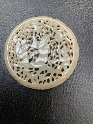 Lot 52 - A Chinese pierced jade circular box and cover,...