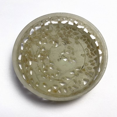 Lot 52 - A Chinese pierced jade circular box and cover,...