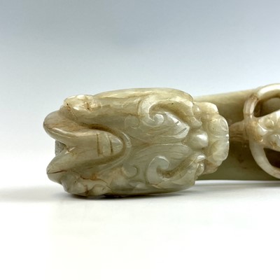 Lot 44 - A Chinese jade belt hook, Qing Dynasty, carved...