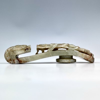 Lot 44 - A Chinese jade belt hook, Qing Dynasty, carved...
