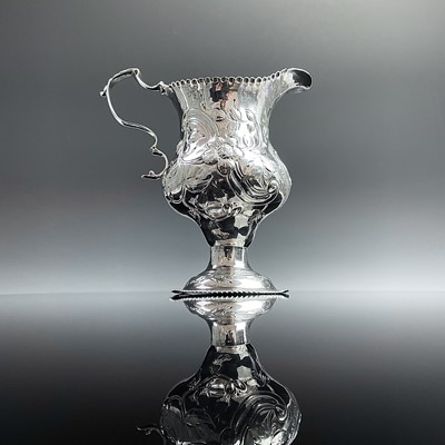 Lot 108 - A George III silver pedestal milk jug by...
