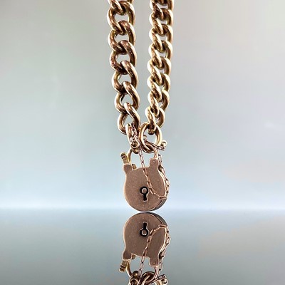 Lot 623 - A 9ct rose gold curb link bracelet with...