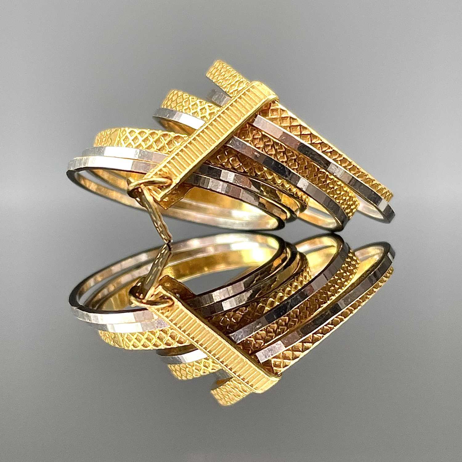 Lot 808 - An Indian 22ct gold seven band ring, stamped