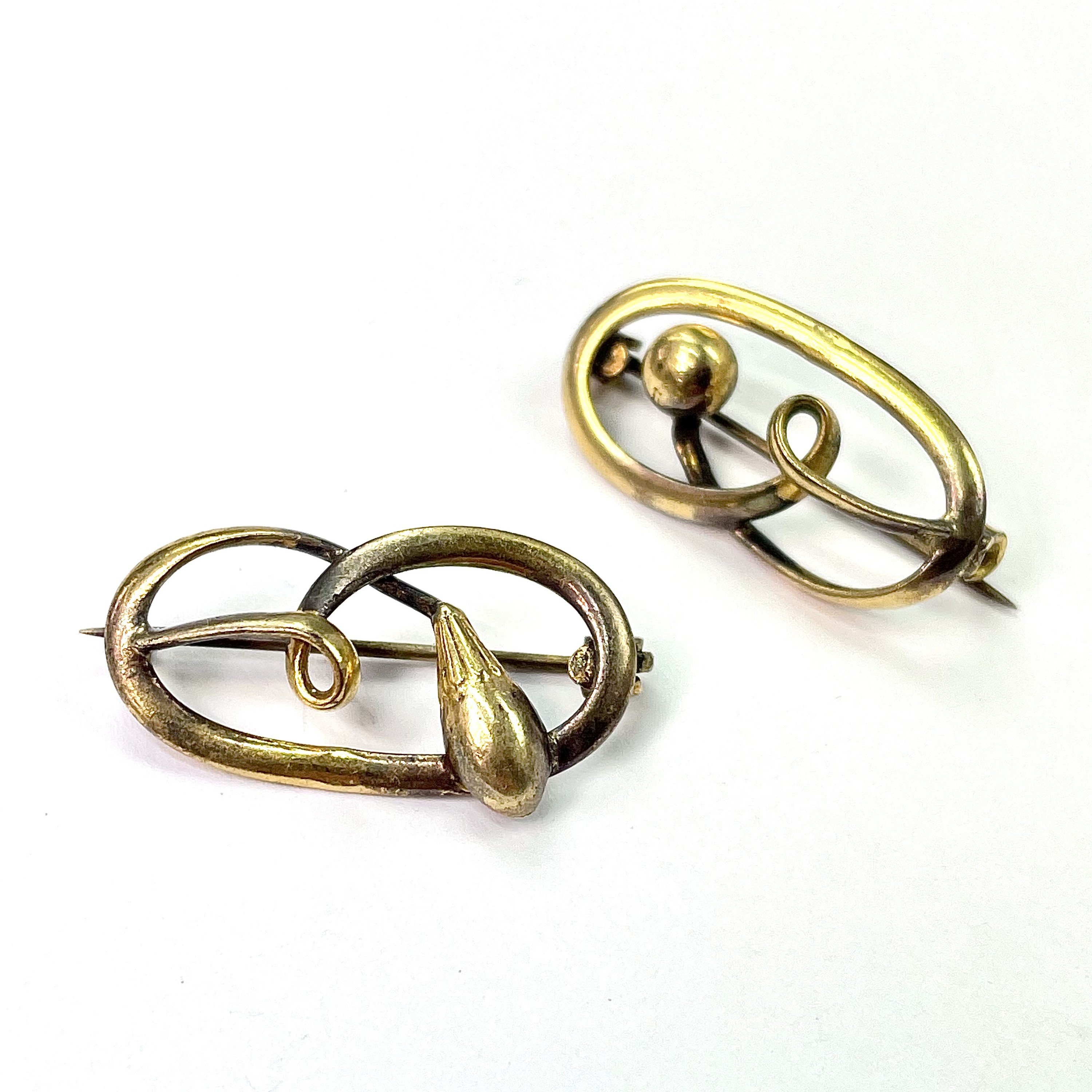 Lot 708 - A near pair of gold open work oval brooches,