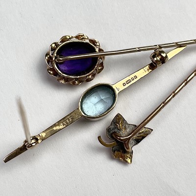 Lot 699 - Two gold tie pins, one set with an amethyst,...