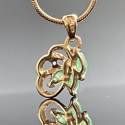 Lot 736 - A 9ct emerald and diamond pendant necklace,...