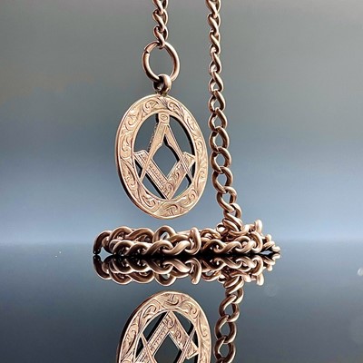 Lot 831 - A 9ct rose gold curb link Albert watch chain...