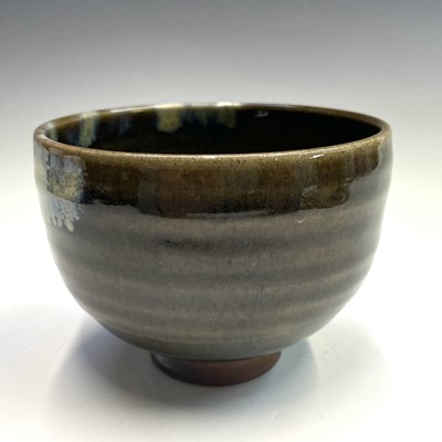 Lot 235 - A Japanese stoneware green glazed chawan,...