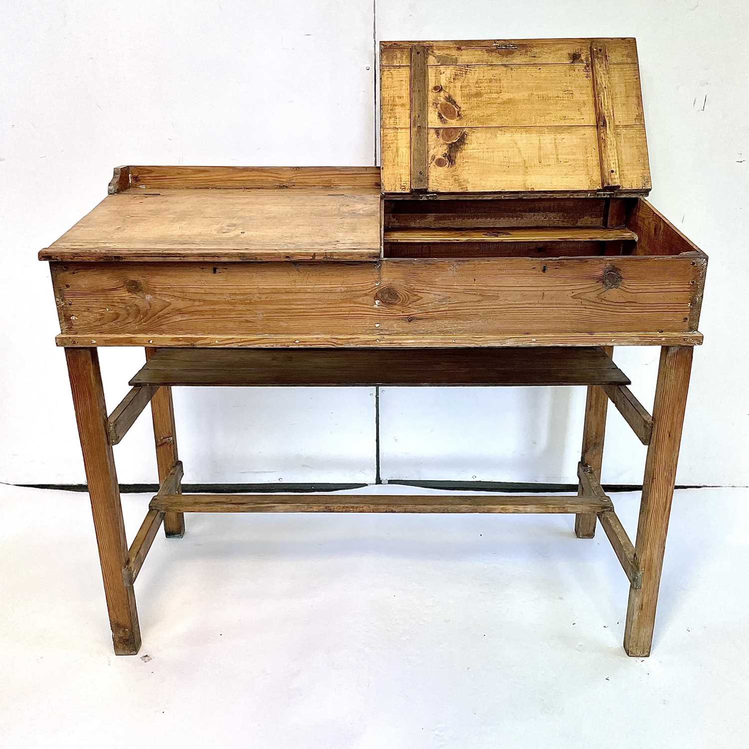 Lot 3117 - A pine clerk's desk, with two sloping lift-up...